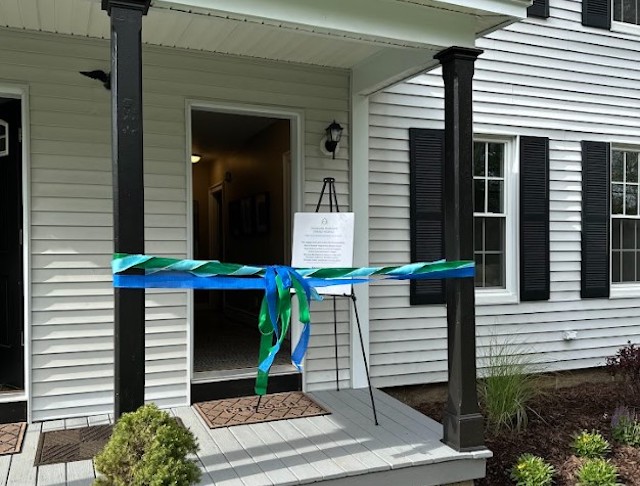 Jonnycake cuts the ribbon at four renovated affordable housing units